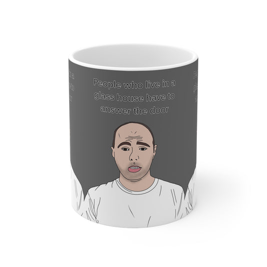 Funny Karl Pilkington Quote Mug — “People who live in a glass house have to answer the door” Cartoon Face Ceramic Coffee Cup